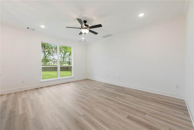 unfurnished room featuring ceiling fan, crown molding, and light hardwood / wood-style flooring