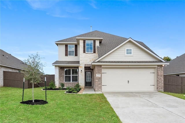 view of front of home with a garage and a front lawn