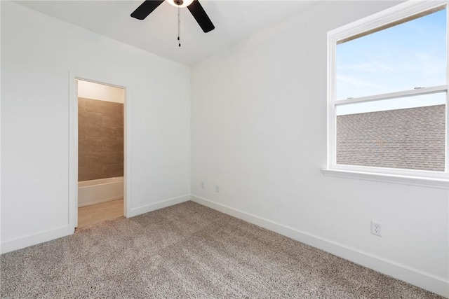 carpeted spare room with ceiling fan