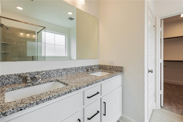 bathroom featuring vanity and an enclosed shower