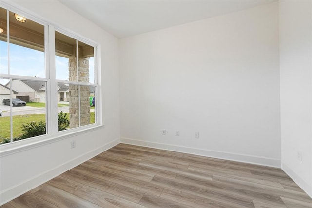 spare room featuring light wood-type flooring