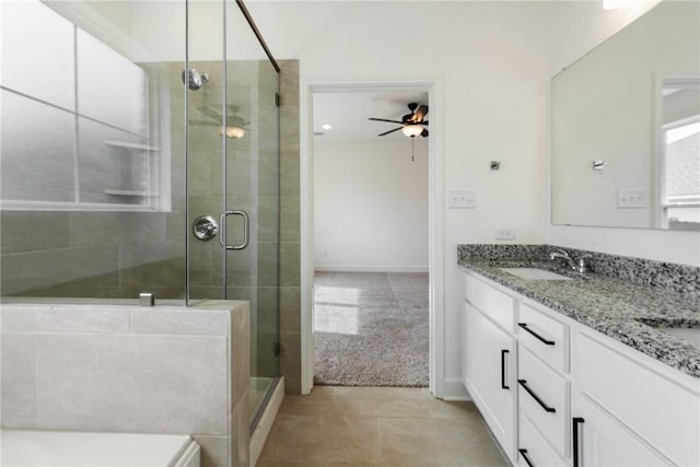 bathroom featuring tile patterned flooring, vanity, ceiling fan, and walk in shower