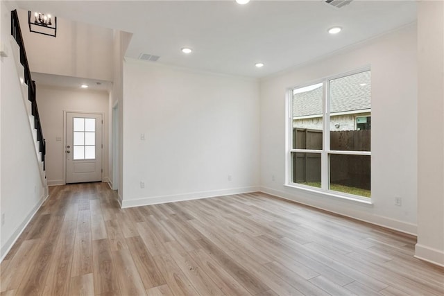 empty room featuring light hardwood / wood-style floors and a chandelier