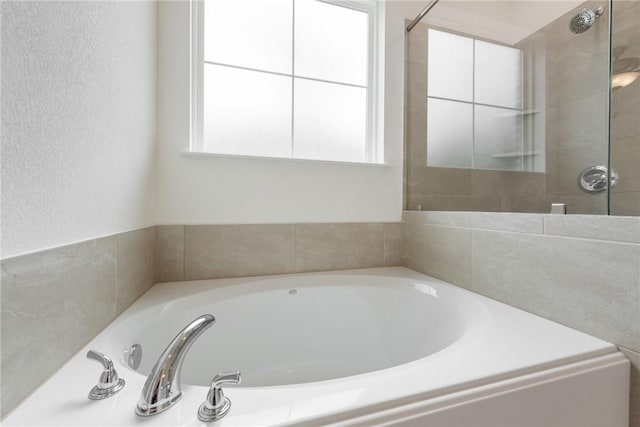 bathroom featuring separate shower and tub