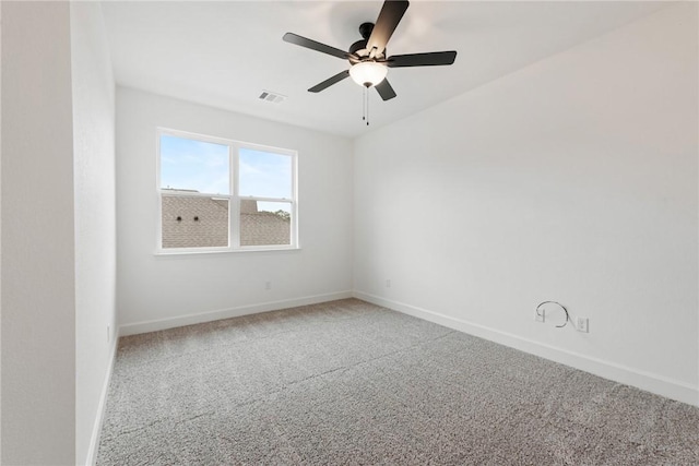 unfurnished room with ceiling fan and carpet