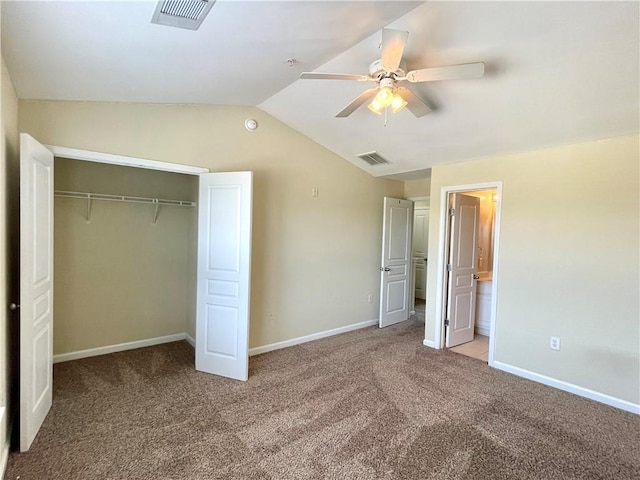 unfurnished bedroom with lofted ceiling, ensuite bathroom, light carpet, a closet, and ceiling fan