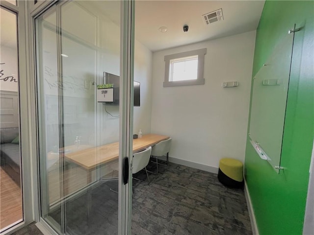 bathroom with toilet and an enclosed shower