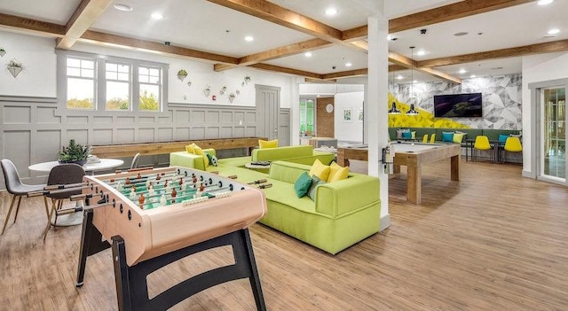 game room with coffered ceiling, light hardwood / wood-style flooring, and beamed ceiling