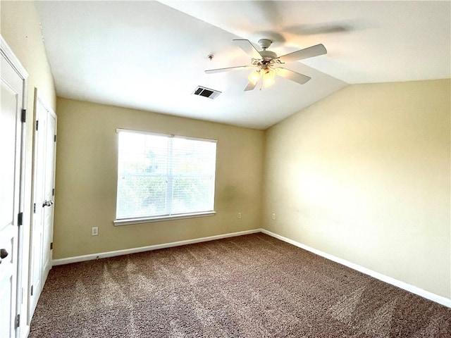 empty room with lofted ceiling, ceiling fan, and carpet