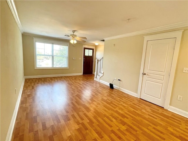 unfurnished room with hardwood / wood-style flooring, crown molding, and ceiling fan