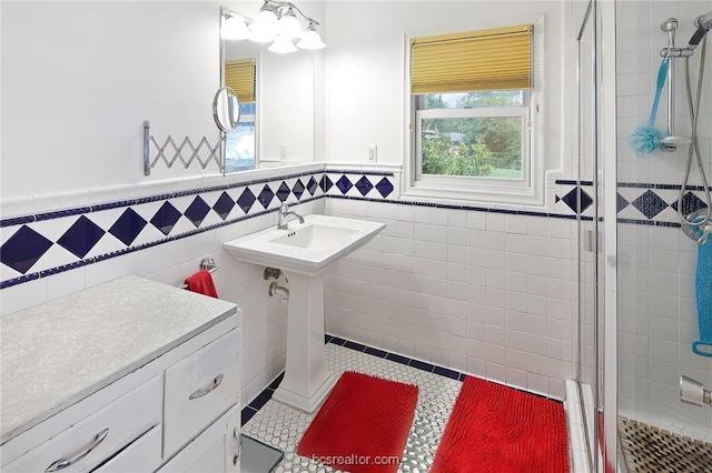 bathroom with a shower with shower door and tile walls