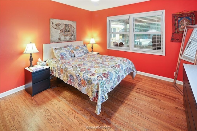 bedroom featuring light hardwood / wood-style floors and multiple windows