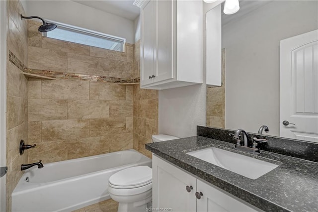 full bathroom featuring tiled shower / bath combo, toilet, and vanity