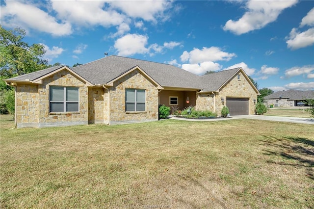 view of front of home with a front yard and a garage