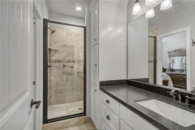 bathroom with vanity and a shower with door