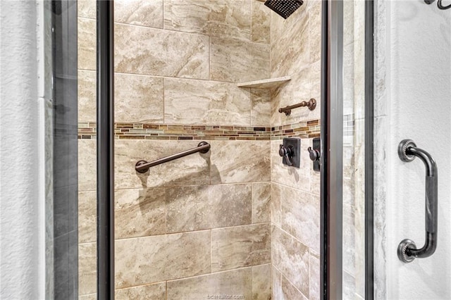 interior details with a shower with door