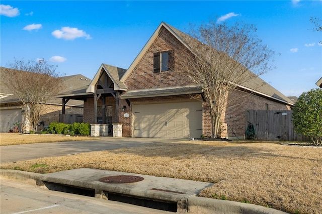 view of front of property featuring a garage and a front lawn