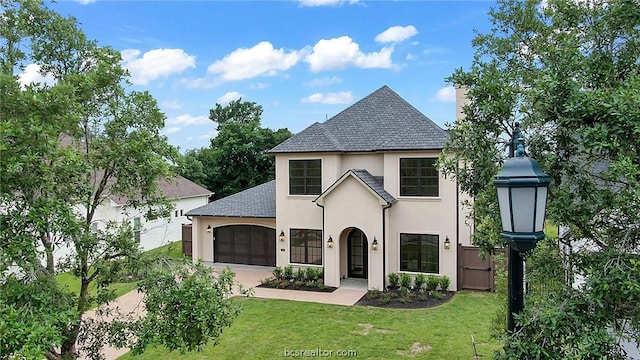 view of front facade with a garage and a front lawn