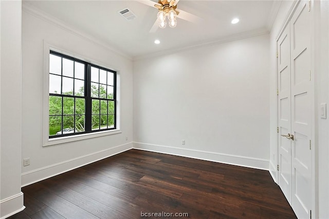 empty room featuring ceiling fan, dark hardwood / wood-style floors, and ornamental molding