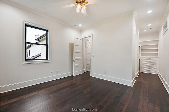 empty room featuring ceiling fan, dark hardwood / wood-style flooring, and ornamental molding