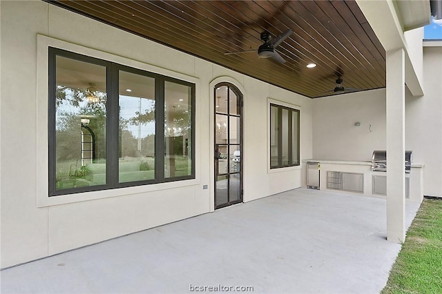 view of patio / terrace with an outdoor kitchen, ceiling fan, and grilling area