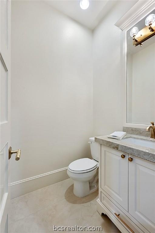 bathroom featuring vanity and toilet