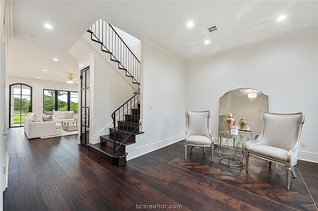 living area with ceiling fan and dark hardwood / wood-style flooring