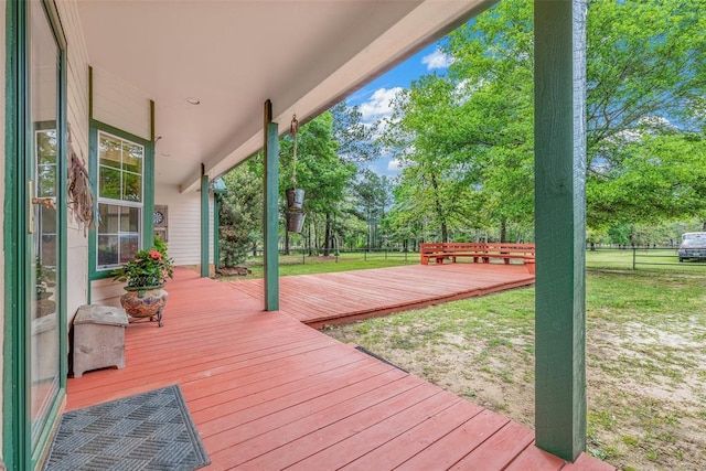 wooden deck featuring a lawn