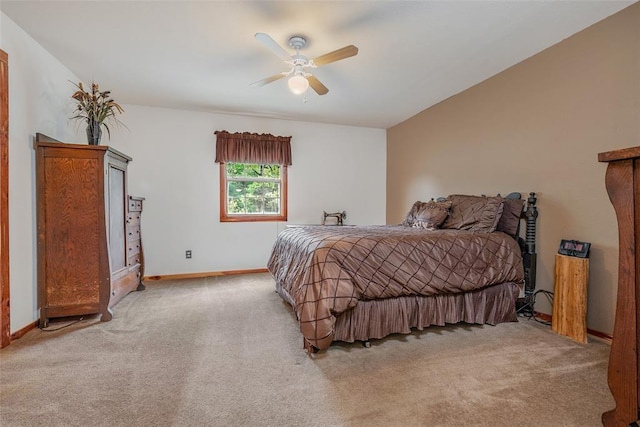 bedroom featuring lofted ceiling, light colored carpet, and ceiling fan