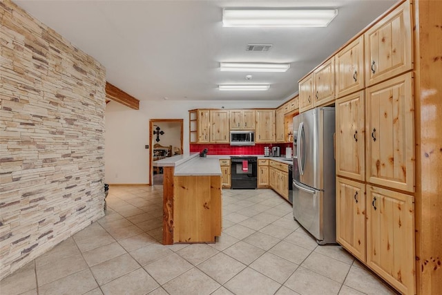 kitchen featuring light brown cabinetry, stainless steel appliances, kitchen peninsula, and light tile patterned flooring