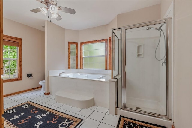 bathroom with ceiling fan, tile patterned floors, plus walk in shower, and toilet