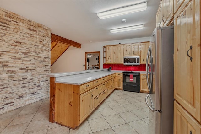 kitchen featuring lofted ceiling, light tile patterned floors, appliances with stainless steel finishes, decorative backsplash, and kitchen peninsula