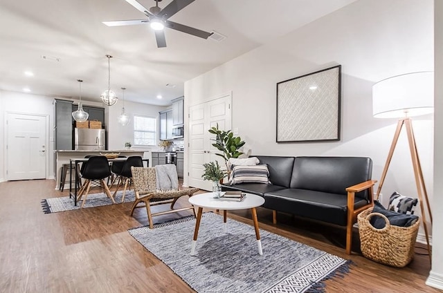 living room featuring hardwood / wood-style floors and ceiling fan