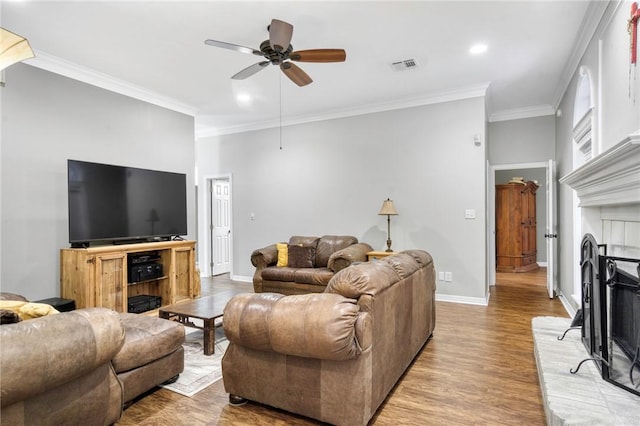 5303 Creek Ln, College Station, TX 77845 - living area with a fireplace, wood finished floors, crown molding, ceiling fan, and baseboards