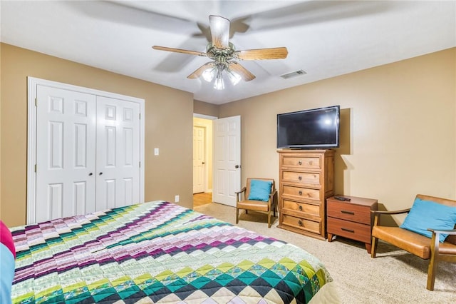 5303 Creek Ln, College Station, TX 77845 - bedroom with light carpet, a closet, and a ceiling fan