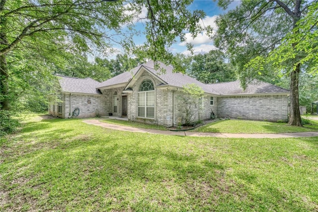 5303 Creek Ln, College Station, TX 77845 - back of house featuring a yard, brick siding, and a shingled roof
