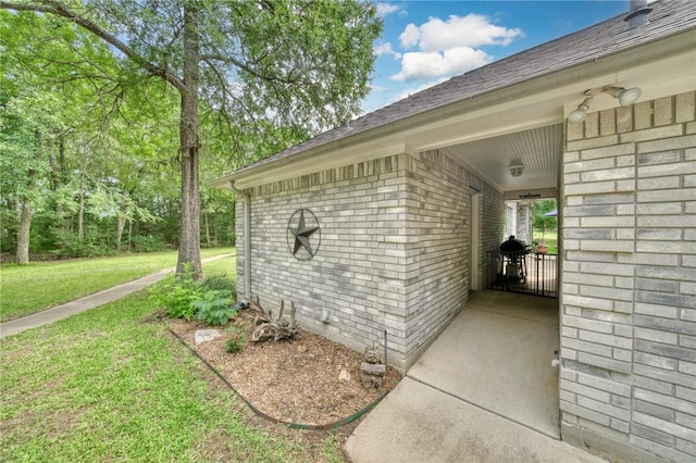 5303 Creek Ln, College Station, TX 77845 - view of property exterior with brick siding, a lawn, and a shingled roof
