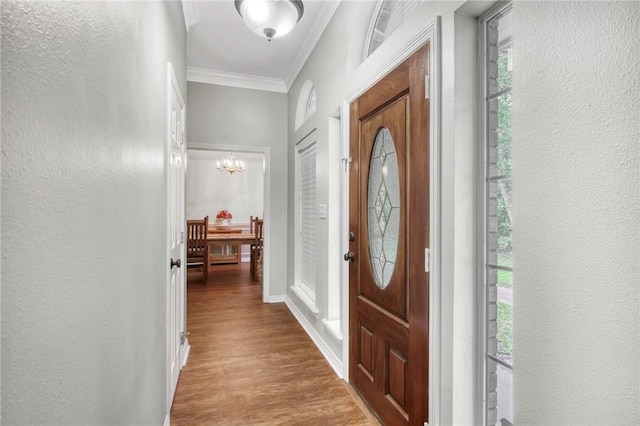 5303 Creek Ln, College Station, TX 77845 - foyer entrance with crown molding, wood finished floors, a chandelier, a textured wall, and healthy amount of natural light
