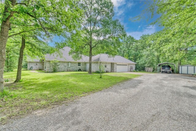 5303 Creek Ln, College Station, TX 77845 - ranch-style home with a carport, driveway, a front yard, and a garage