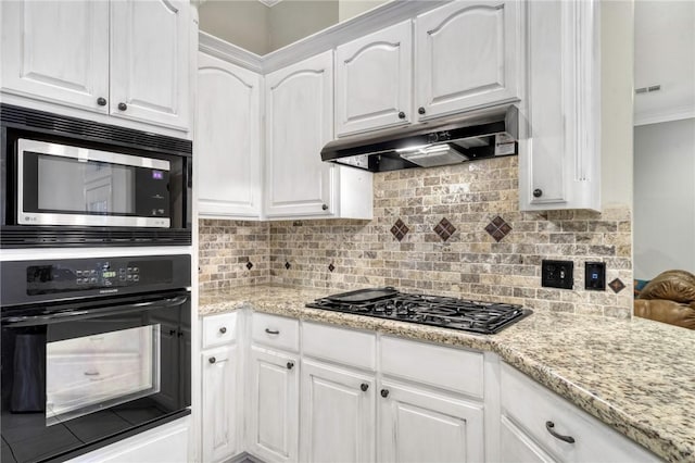5303 Creek Ln, College Station, TX 77845 - kitchen with black appliances, under cabinet range hood, white cabinetry, crown molding, and backsplash