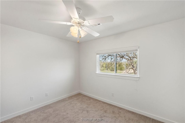 spare room with light carpet and ceiling fan