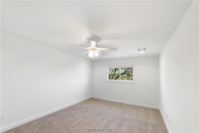 empty room featuring light colored carpet and ceiling fan