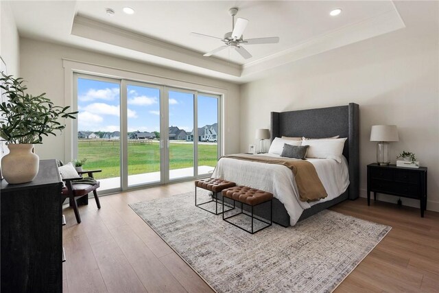 7800 Mathis Creek Dr, Bryan, TX 77808 - bedroom featuring access to exterior, light wood-type flooring, a raised ceiling, ornamental molding, and recessed lighting