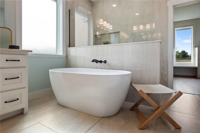 7800 Mathis Creek Dr, Bryan, TX 77808 - full bathroom featuring a freestanding bath, baseboards, plenty of natural light, and walk in shower