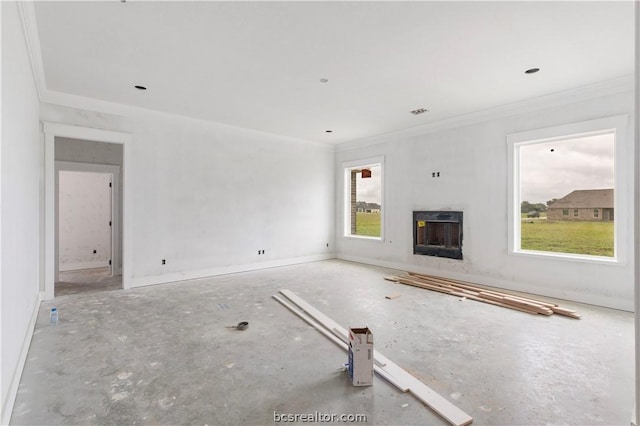 unfurnished living room featuring crown molding and a healthy amount of sunlight