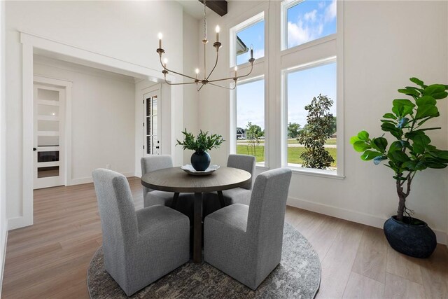 7800 Mathis Creek Dr, Bryan, TX 77808 - dining space with an inviting chandelier, wood finished floors, and a wealth of natural light