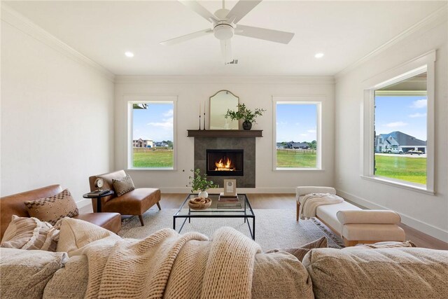7800 Mathis Creek Dr, Bryan, TX 77808 - living room featuring ceiling fan, visible vents, a tile fireplace, baseboards, and light wood-style flooring