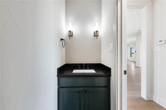 bathroom featuring wood-type flooring and vanity