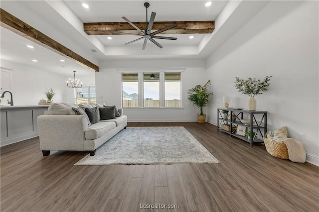 living room featuring beam ceiling, a healthy amount of sunlight, and dark hardwood / wood-style floors