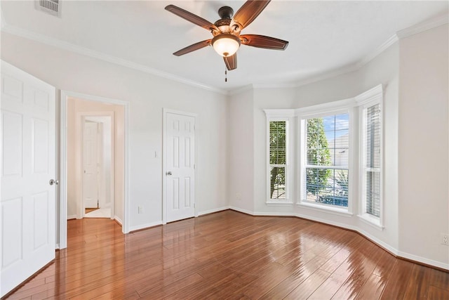 5106 Bellerive Bend Dr, College Station, TX 77845 - unfurnished room featuring visible vents, crown molding, baseboards, ceiling fan, and wood finished floors